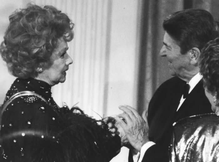 President Ronald Reagan greets Lucille Ball during a ceremony in the East Room of the White House in Washington on December 7, 1986. Ball was born on this day in 1911. File Photo by Vince Mannino/UPI