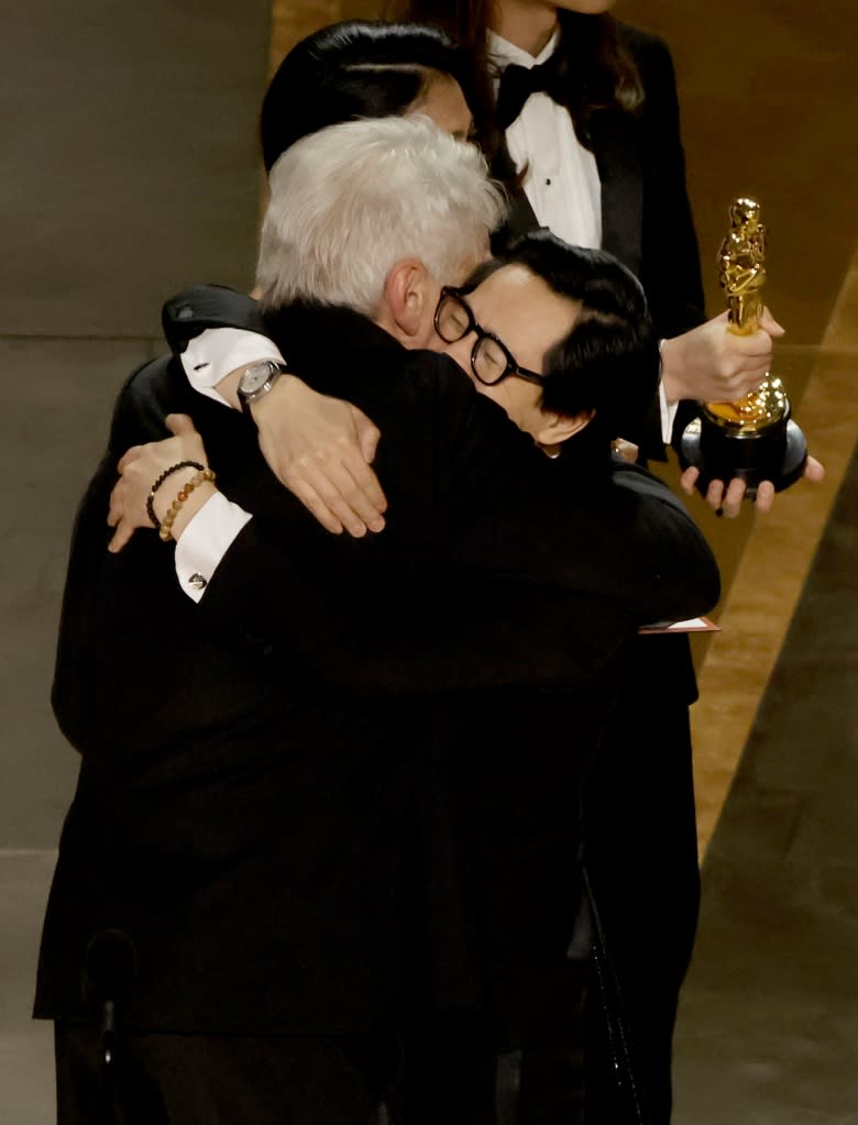 HOLLYWOOD, CALIFORNIA - MARCH 12: Ke Huy Quan (R) accepts the award for Best Picture for "Everything Everywhere All at Once" from Harrison Ford onstage during the 95th Annual Academy Awards at Dolby Theatre on March 12, 2023 in Hollywood, California. (Photo by Kevin Winter/Getty Images)