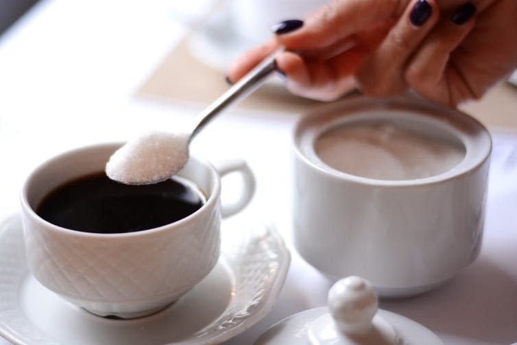 <span class="caption">Having a hot drink without sugar is one way of cutting out a regular sugar hit.</span> <span class="attribution"><a class="link " href="https://www.shutterstock.com/image-photo/woman-hand-adding-sugar-coffee-bowl-719682535?src=Pmgd_OrgZ3TukMnk8sFK2A-1-0" rel="nofollow noopener" target="_blank" data-ylk="slk:Eviart/Shutterstock;elm:context_link;itc:0;sec:content-canvas">Eviart/Shutterstock</a></span>