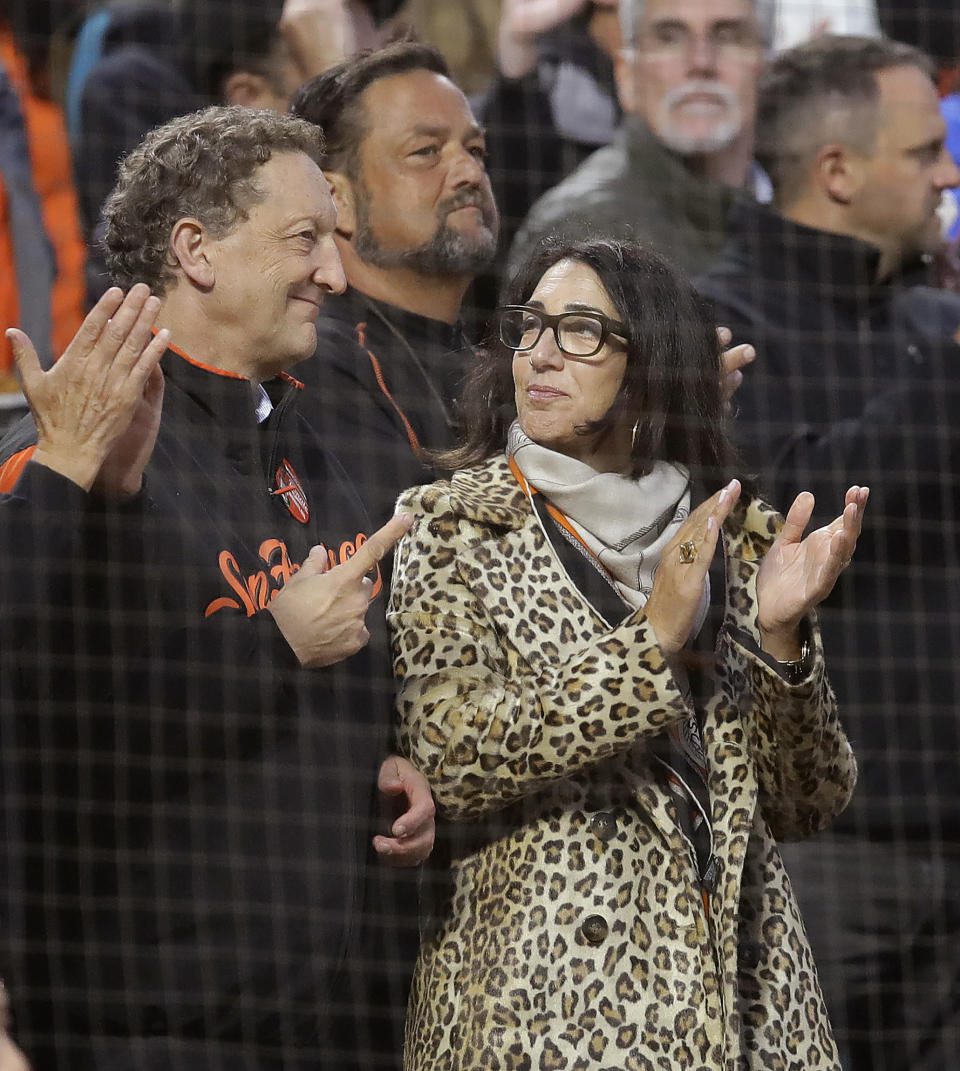 San Francisco Giants CEO Larry Baer and his wife, Pamela Baer, stand for the playing of "God Bless America" during the seventh inning of the team's baseball game against the New York Mets on Thursday, July 18, 2019, in San Francisco. (AP Photo/Ben Margot)