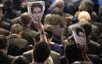 Participants hold up images of former NSA analyst Edward Snowden during the opening ceremony of NETmundial, a major conference on the future of Internet governance in Sao Paulo, Brazil, Wednesday, April 23, 2014. Brazil has cast itself as a defender of Internet freedom following revelations last year that Rousseff was the object of surveillance by the United States' National Security Agency. She canceled a state visit to the U.S. last October over the revelations, which came out of leaks by Snowden and showed Brazil's state-run Petrobras was also the object of American spying. (AP Photo/Andre Penner)