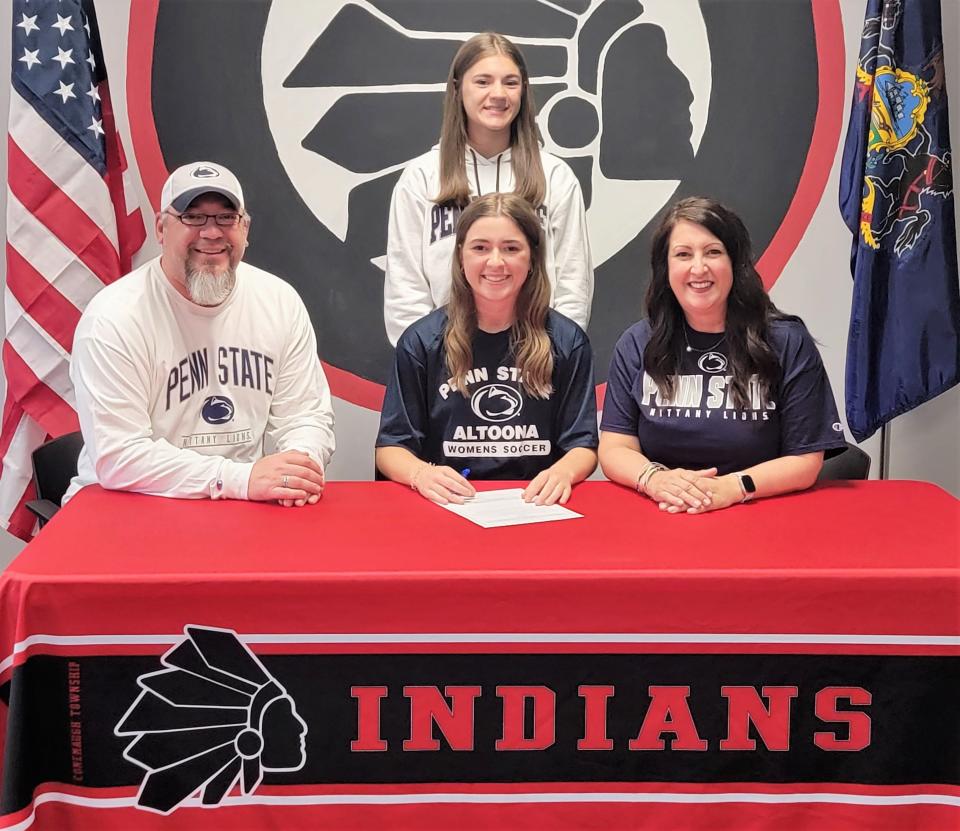 Flanked by parents Eric and Michele Roman, Conemaugh Township senior Emilee Roman announces her intentions to play soccer at Penn State Altoona, May 23, in Davidsville. In back is Roman's sister Madee Roman.