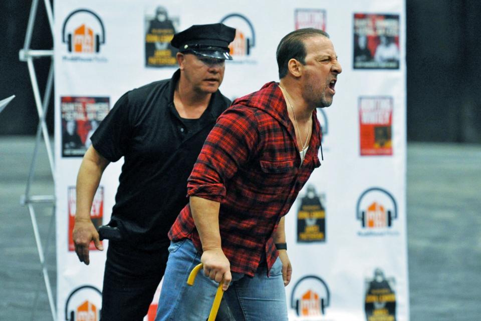 Greg Floyd, played by Patrick Languzzi, right, erupts at a judge after being found guilty of threatening a neighbor, and is escorted by a court officer played by Donny Saint John, left, during rehearsal of the show "Saints, Sinners & Serial Killers" at the Marina Bay Studios in Quincy, Sunday, April 10, 2022.