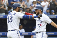 Toronto Blue Jays' Breyvic Valera celebrates his two-RBI home run with Lourdes Gurriel Jr. in the fourth inning of a baseball game against the Oakland Athletics in Toronto on Saturday, Sept. 4, 2021. (Jon Blacker/The Canadian Press via AP)