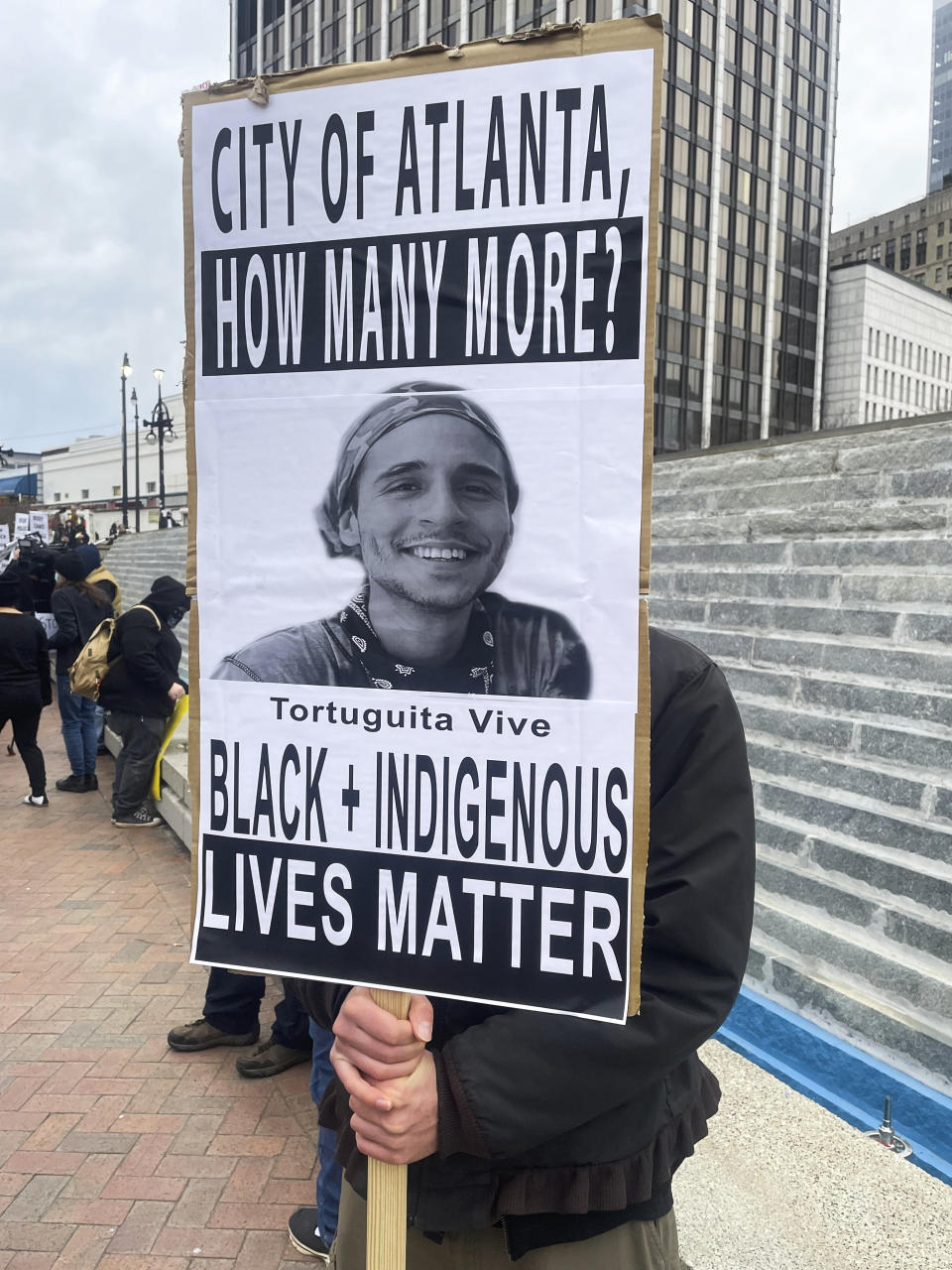 A demonstrator holds a sign protesting the death of an environmental activist, who went by Tortuguita, in Atlanta on Saturday, Jan. 21, 2023. Tortuguita was killed Wednesday, Jan. 18, after authorities said the 26-year-old shot a state trooper. Activists have questioned officials’ version of events, demanding an independent investigation. (AP Photo/R.J. Rico)