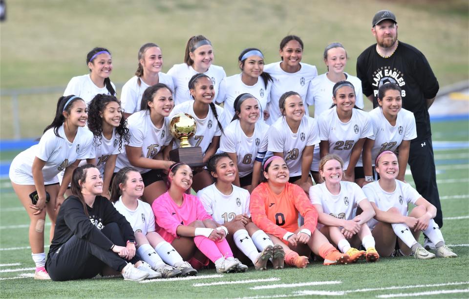 The Abilene High girls soccer team poses with the area championship trophy after beating El Paso High 4-2 in a Region I-5A playoff game Monday in Midland. It's the Lady Eagles' first second-round playoff win since 2002.