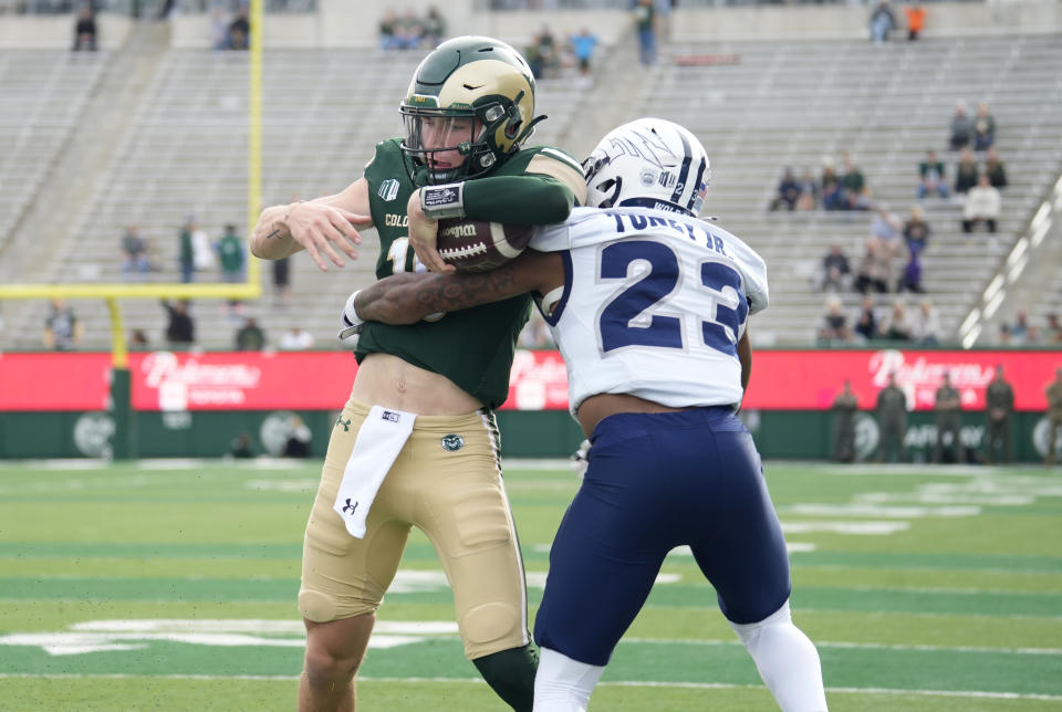 Colorado State quarterback Brayden Fowler-Nicolosi, left, is stopped short of the goal line after a small gain by Nevada defensive back Richard Toney Jr. in the first half of an NCAA college football game Saturday, Nov. 18, 2023, in Fort Collins, Colo. (AP Photo/David Zalubowski)