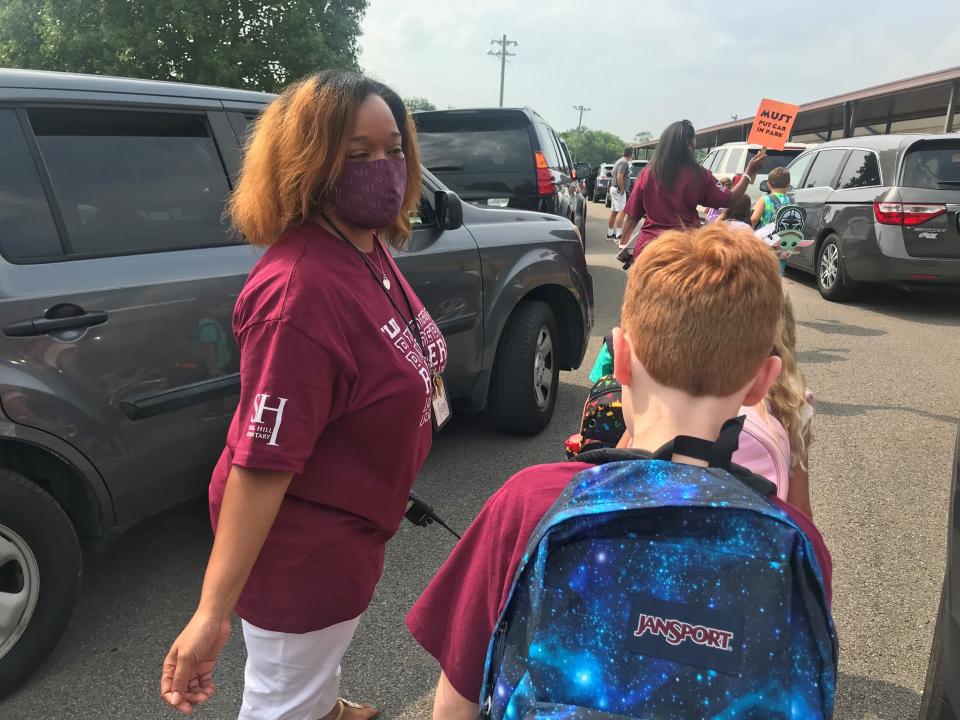 Spring Hill Elementary School Principal Renata Powell ushers students through the pick-up line during dismissal on the first day of school in Maury County Public Schools on August 2, 2021.