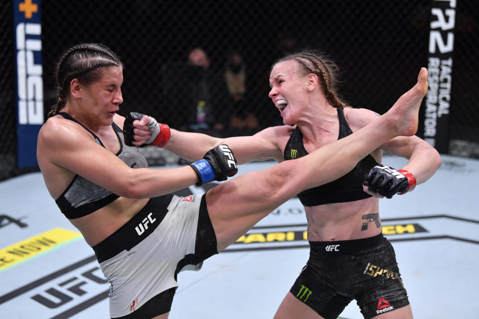 LAS VEGAS, NEVADA - NOVEMBER 21:  (R-L) Valentina Shevchenko of Kyrgyzstan and Jennifer Maia of Brazil exchange strikes in their women's flyweight championship bout during the UFC 255 event at UFC APEX on November 21, 2020 in Las Vegas, Nevada. (Photo by Jeff Bottari/Zuffa LLC)