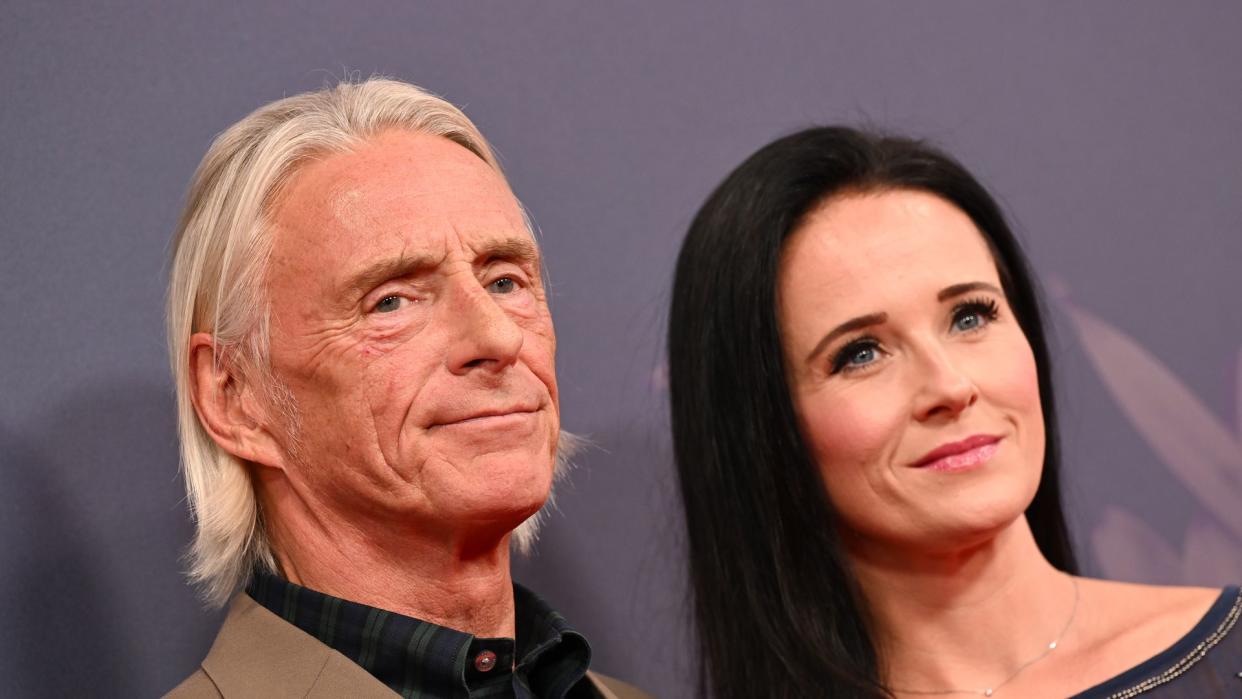 couple smiling on red carpet