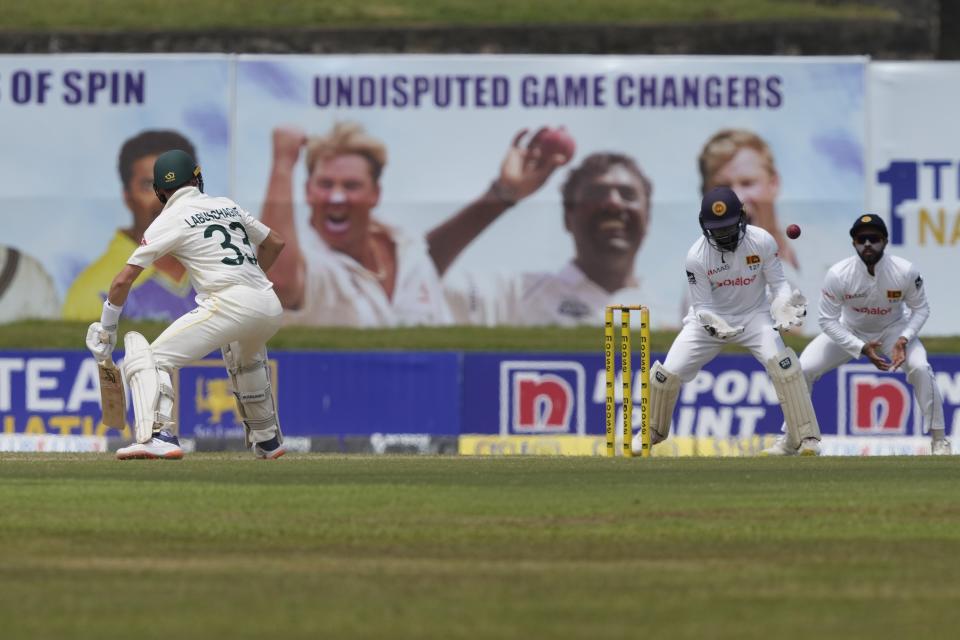 Sri Lanka's Niroshan Dickwella, second right, misses a possible stumping chance to dismiss Australia's Marnus Labuschagne, left, during the first day of the second cricket test match between Australia and Sri Lanka in Galle, Sri Lanka, Friday, July 8, 2022. (AP Photo/Eranga Jayawardena)