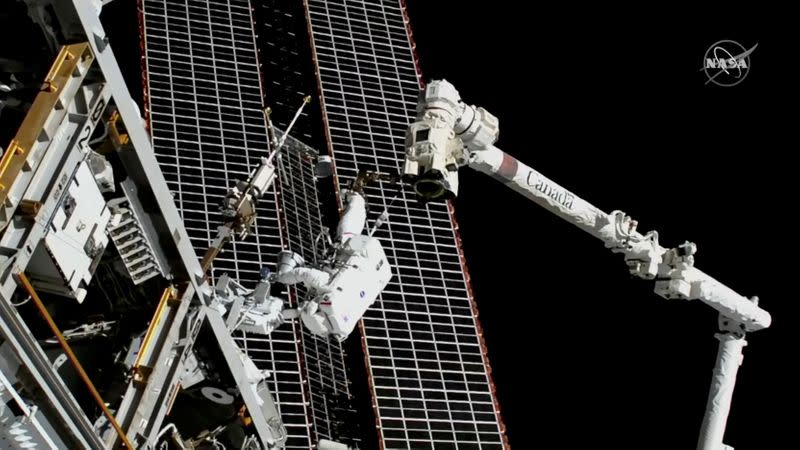 Astronauts conduct a spacewalk to replace a faulty antenna on the International Space Station