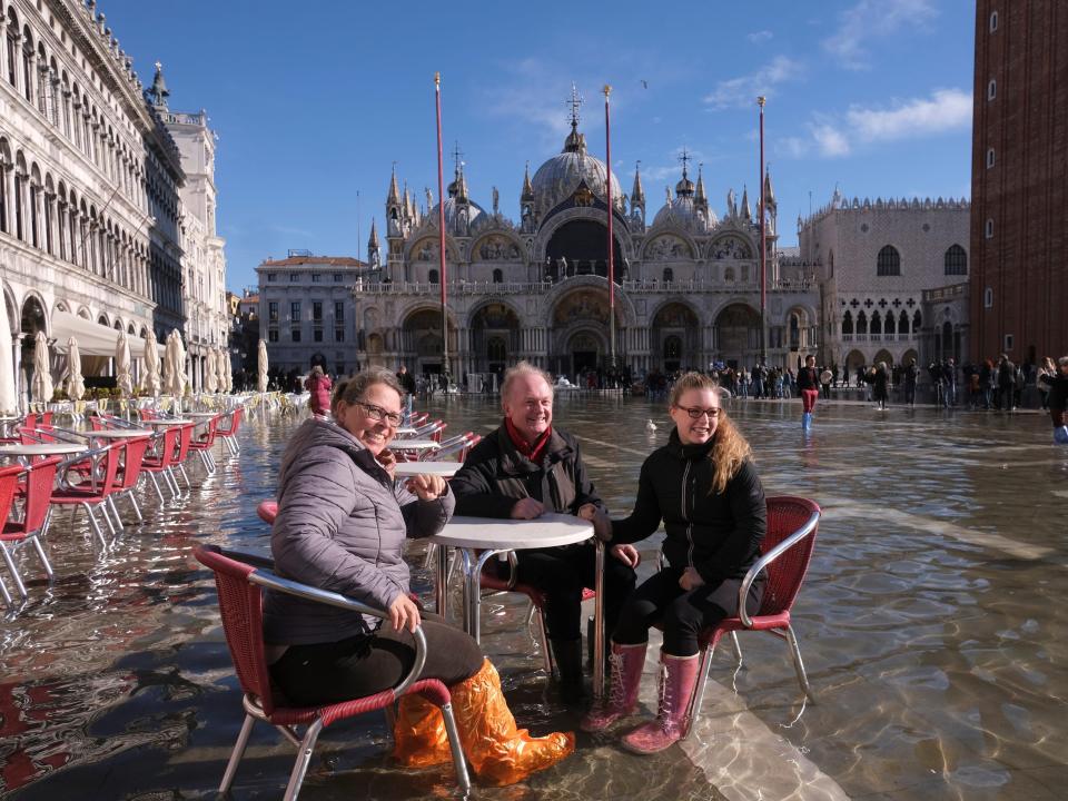 People sit at a cafe in a flooded St. Mark's Square during seasonally high water in Venice, Italy November 5, 2021.