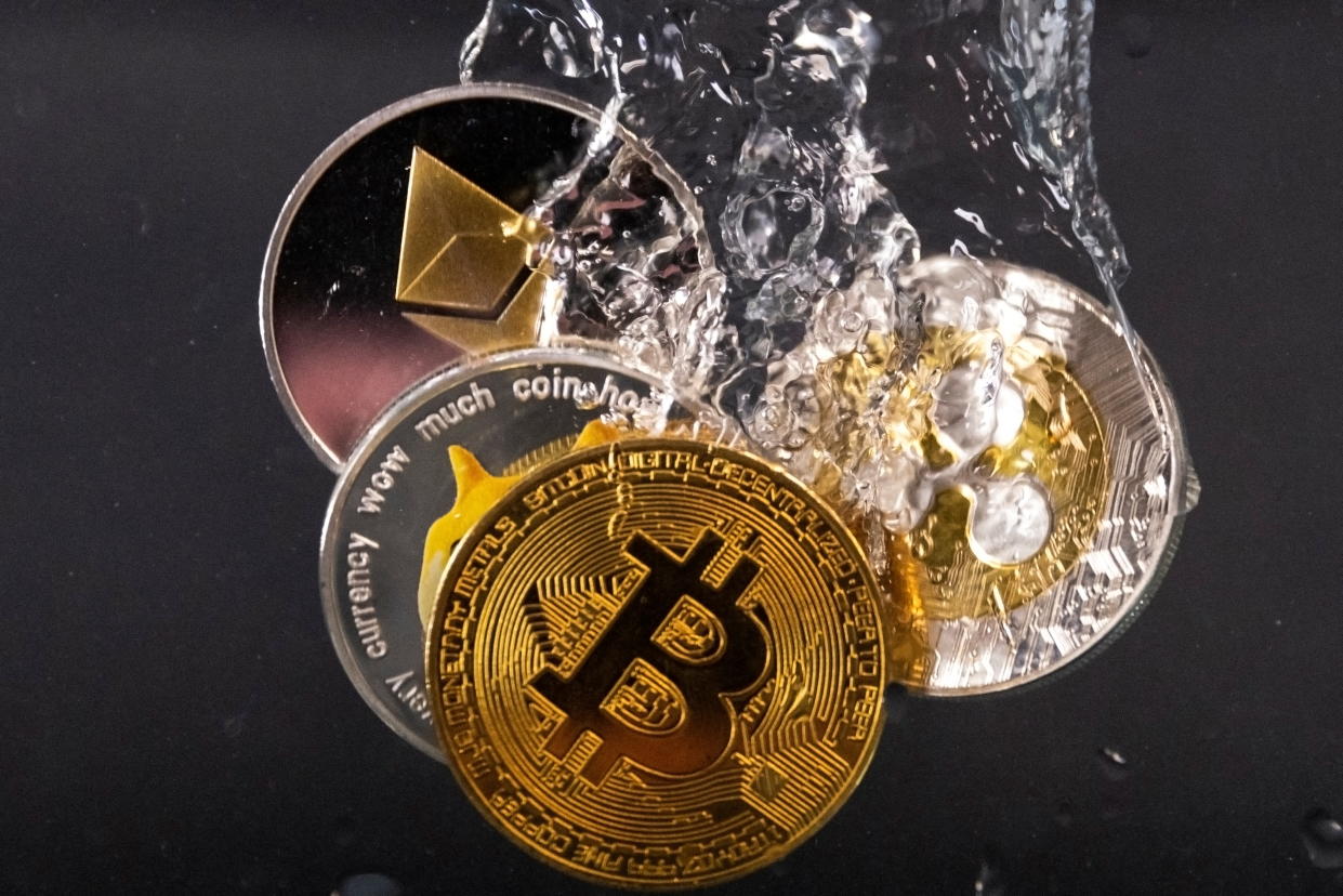 Souvenir tokens representing cryptocurrencies Bitcoin, Ethereum, Dogecoin and Ripple plunge into water in this illustration taken May 17, 2022. REUTERS/Dado Ruvic/Illustration