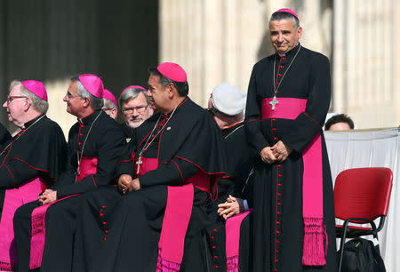 Archbishop of Rouen Dominique Lebrun (R) stands up as Pope Francis leads his weekly audience at the Vatican, September 14, 2016. REUTERS/Alessandro Bianchi