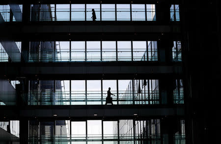 A man walks on a footbridge in the new NATO headquarters during the move to the new building, in Brussels, Belgium April 19, 2018. REUTERS/Yves Herman