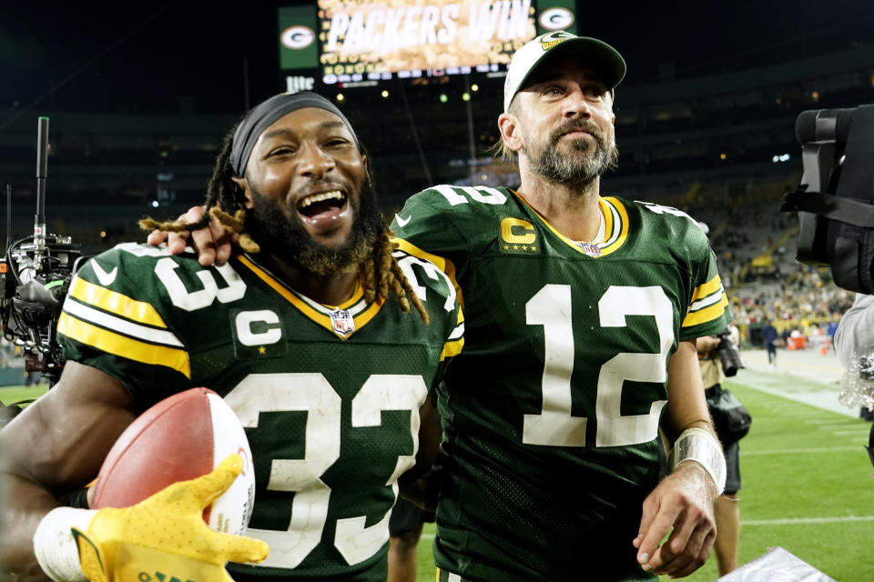 Green Bay Packers running back Aaron Jones (33) walks off the field with teammate quarterback Aaron Rodgers (12) after an NFL football game against the Chicago Bears Sunday, Sept. 18, 2022, in Green Bay, Wis. The Packers won 27-10. (AP Photo/Morry Gash)