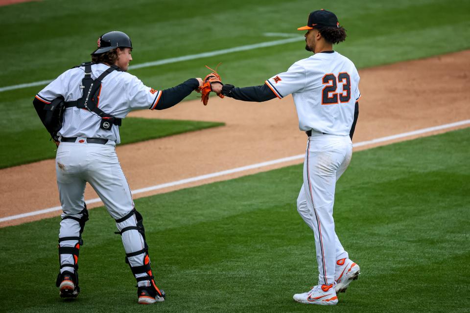 Oklahoma State pitcher Juaron Watts-Brown (23) and catcher Ian Daugherty fist bump during the Cowboys' game against Loyola Marymount at O’Brate Stadium in Stillwater on Saturday.