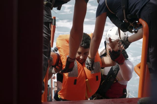 A man is helped on to the Ocean Viking