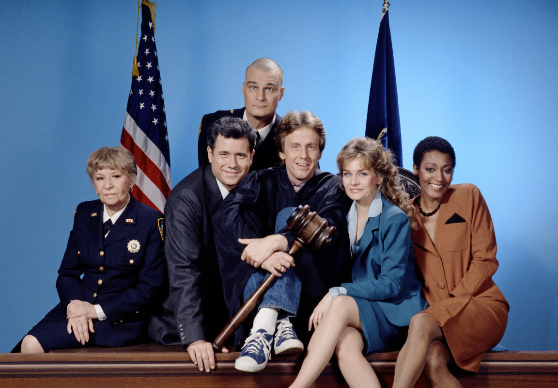 <p>NBC/Getty Images</p><p>The cast of the first season of the original iteration of <em>Night Court</em>, from left to right: <strong>Selma Diamond </strong>as Bailiff Selma Hacker, <strong>John Larroquette </strong>as Daniel R. "Dan" Fielding, <strong>Richard Moll</strong> as bailiff Nostradamus "Bull" Shannon, <strong>Harry Anderson</strong> as Judge Harold "Harry" T. Stone, <strong>Karen Austin</strong> as Lana Wagner and <strong>Paula Kelly</strong> as Public Defender Liz Williams.</p>