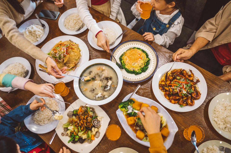 An Asian Chinese family enjoy their home made food during Chinese new year's eve reunion dinner at home