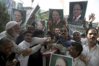 Supporters of Pakistani Prime Minister Nawaz Sharif celebrate the suspension of prison sentences of Sharif, his daughter and son-in-law, in Lahore, Pakistan, Wednesday, Sept. 19, 2018. The Islamabad High Court set them free on bail pending their appeal hearings. The court made the decision on the corruption case handed down to the Sharifs by an anti-graft tribunal earlier this year. (AP Photo/K.M. Chaudary)