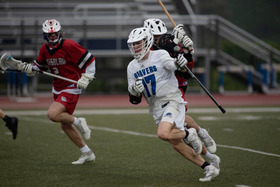 Harper Creek senior Blake Bess (17) runs with the ball at Harper Creek High School on Wednesday, May 18, 2022.