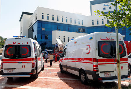 Ambulances are seen near the headquarters of Libyan state oil firm National Oil Corporation (NOC) after three masked persons attacked it in Tripoli, Libya September 10, 2018. REUTERS/Ismail Zitouny