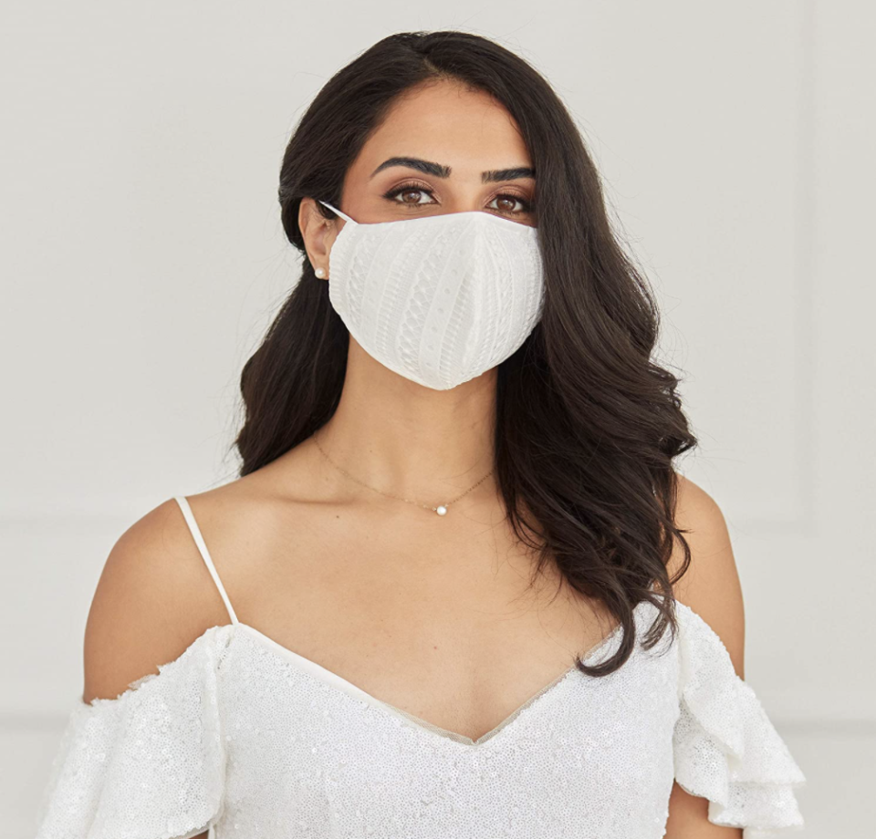 white lace face mask on woman wearing white wedding dress