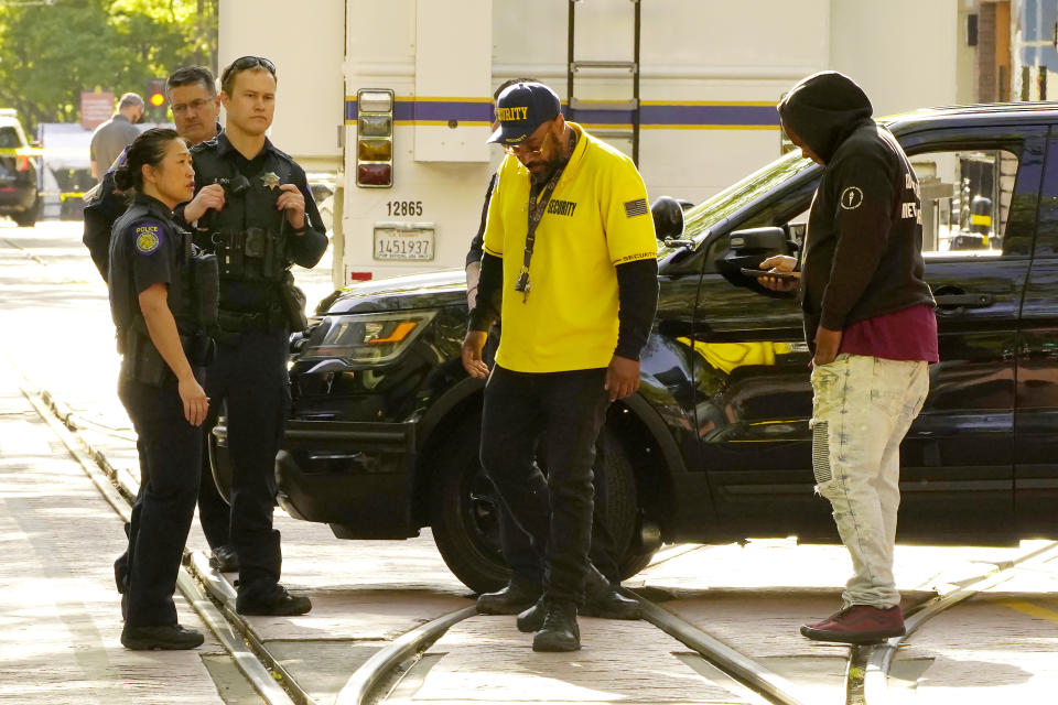 Frank Turner, center, turns away after Sacramento Police Officers do not allow him to look for his son, who he believes might be one of the six people killed in a mass shooting in Sacramento, Calif. April 3, 2022. (AP Photo/Rich Pedroncelli)