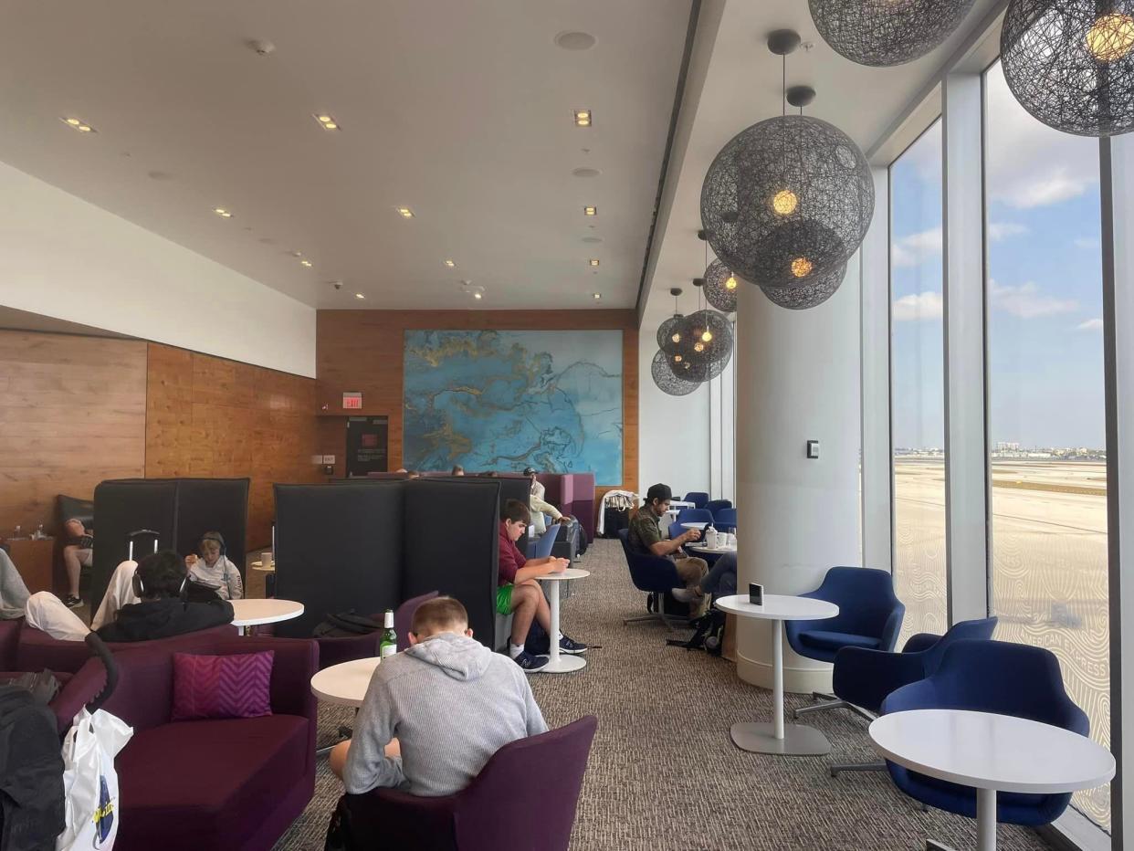 People sitting in an airport lounge.