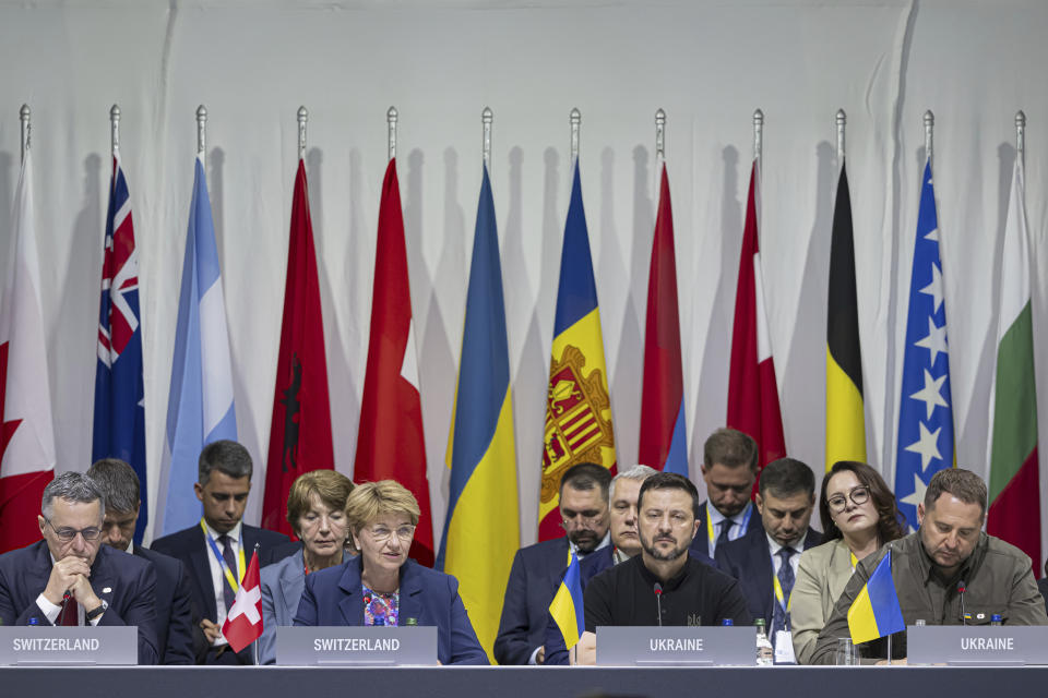 From left: Swiss Federal Councilor Ignazio Cassis, Swiss Federal President Viola Amherd, Ukrainian President Volodymyr Zelenskyy and Ukraine Head of the presidential Office of Ukraine Andriy Yermak attend the plenary session during the Summit on peace in Ukraine, in Obbürgen, Switzerland, Sunday, June 16, 2024. (Urs Flueeler/Keystone via AP)