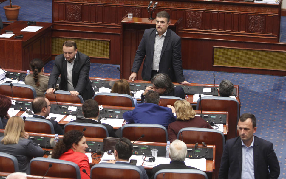 Lawmakers of the ruling SDSM wait before voting for the proposal on a motion for constitutional revision during a session of the Macedonian Parliament in the capital Skopje, Friday, Oct. 19, 2018. Lawmakers in Macedonia on Friday backed the landmark proposal to amend the constitution, allowing the country to change its name and join NATO. (AP Photo/Boris Grdanoski)