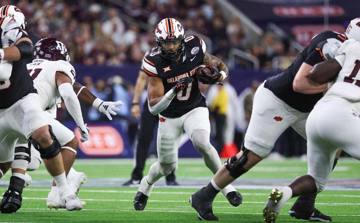 Dec 27, 2023; Houston, TX, USA; Oklahoma State Cowboys running back Ollie Gordon II (0) runs with the ball during the first quarter against the Texas A&M Aggies at NRG Stadium. Mandatory Credit: Troy Taormina-USA TODAY Sports