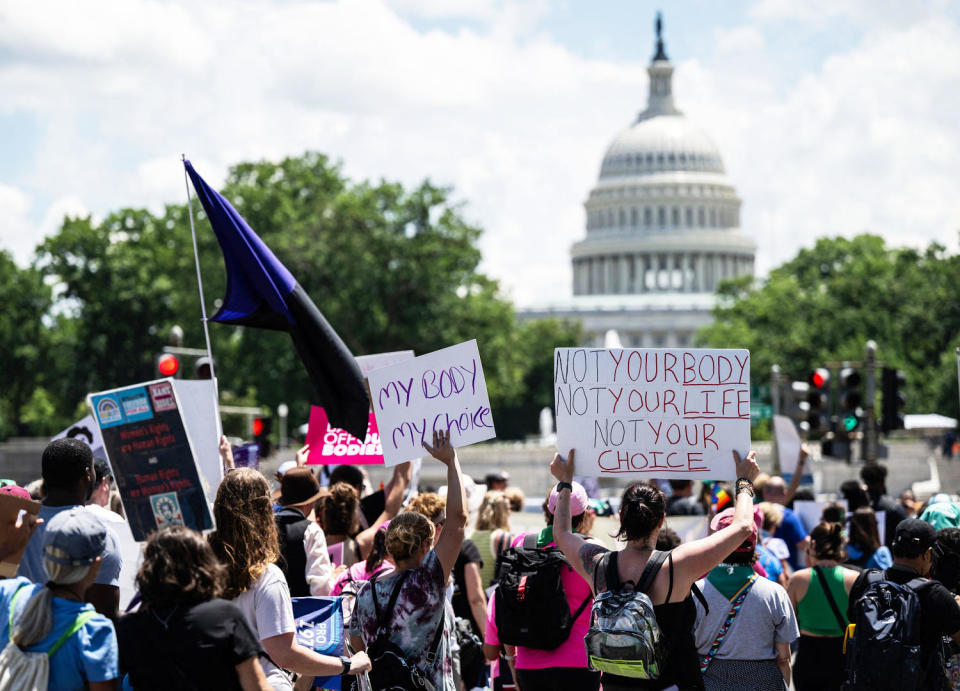 Abortion rights demonstrators holds signs and flags while rallying in Washington, D.C., with the Capitol dome in the background (Andrew Caballero-Reynolds / AFP via Getty Images file)