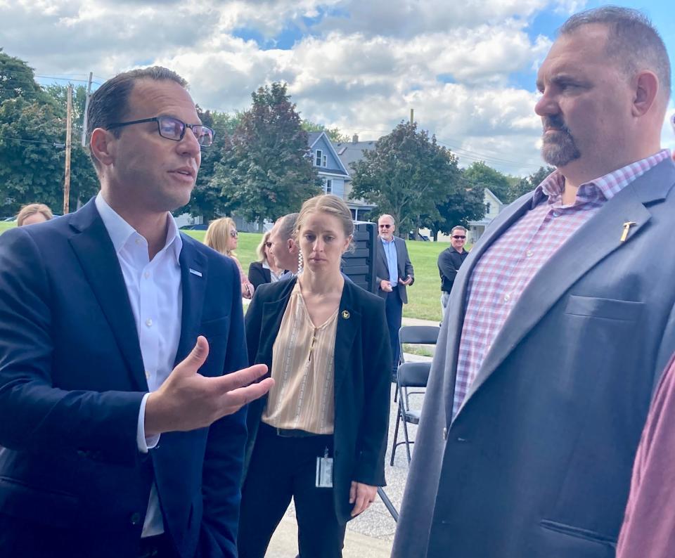 Gov. Josh Shapiro, left, speaks with Todd Deitrick of Sheet Metal Workers Local 12 during a kickoff event for Bayfront Parkway improvements Sept. 15.