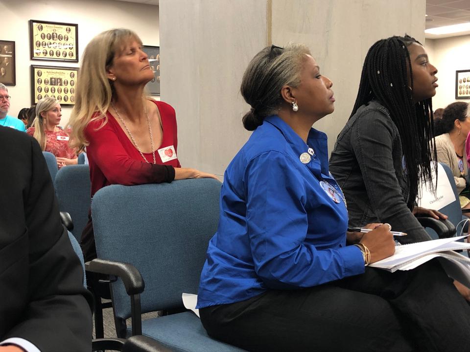 Someone for and against a bill banning abortions in South Carolina after a fetal heartbeat is detected listen to speakers at a state Senate subcommittee public hearing on Tuesday, Sept. 10, 2019, in Columbia, S.C. The bill has already passed the House and is supported by the governor. (AP Photo / Jeffrey Collins)