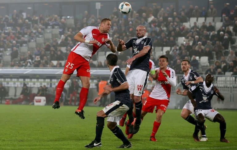 Monaco's Kamil Glik (L) vies with Nicolas Pallois (C) on December 10, 2013 at the Matmut Atlantique Stadium in Bordeaux