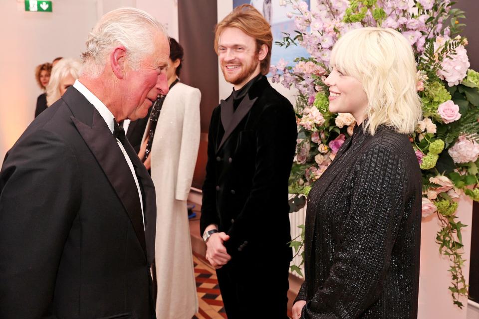 Prince Charles, Prince of Wales, meets "No Time To Die" Performers Finneas and Billie Eilish at the "No Time To Die" World Premiere at Royal Albert Hall on September 28, 2021 in London