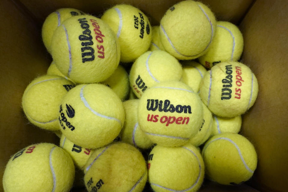 A box of game-used tennis balls rest in a shipping box during the U.S. Open tennis championships, Monday, Sept. 4, 2023, in New York. Because tennis balls are extremely hard to recycle and the industry has yet to develop a ball to make that easier, nearly all of the 330 million balls made worldwide each year eventually get chucked in the garbage, with most ending up in landfills. (AP Photo/Eduardo Munoz Alvarez)