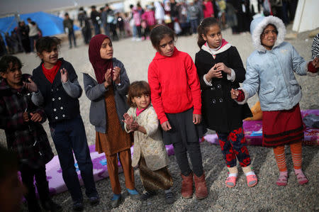 Displaced Iraqi girls play outside tent schools set by United Nations Children's Fund (UNICEF) at Hassan Sham camp, east of Mosul, Iraq December 8, 2016. REUTERS/Mohammed Salem