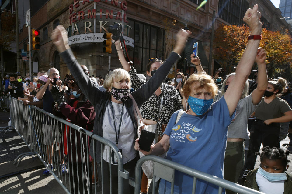 People celebrate outside the Pennsylvania Convention Center, Saturday, Nov. 7, 2020, in Philadelphia, after Democrat Joe Biden defeated President Donald Trump to become 46th president of the United States. (AP Photo/Rebecca Blackwell)