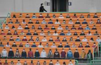 Banners depict spectators in the stands prior to South Korea's new baseball season opening game between SK Wyverns and Hanwha Eagles in Incheon (AFP Photo/Jung Yeon-je)