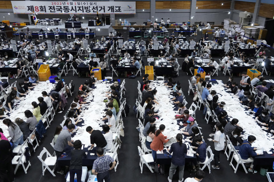 FILE - Election Commission officials sort out ballots for counting at the local elections to elect mayors, governors, council members and education superintendents nationwide at a gymnasium in Seoul, South Korea on June 1, 2022. Members of South Korea’s ruling conservative party have proposed a bill that would place tighter restrictions on the voting rights of foreign permanent residents in local elections, which they insist is necessary to protect the country’s democracy from being undermined by Chinese voters. (AP Photo/Ahn Young-joon, File)