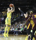 Oregon's Sabrina Ionescu, left, shots over Arizona State's Robbi Ryan, center, and Oregon teammate Ruthy Hebard during the first quarter an NCAA college basketball game Friday, Jan. 18, 2019, in Eugene, Ore. (AP Photo/Chris Pietsch)