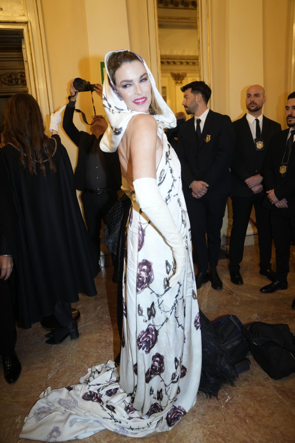 Maria Mantero poses for photographers as she arrives to attend La Scala opera house's gala season opener, Giuseppe Verdi's opera 'Don Carlo' at the Milan La Scala theater, Italy, Thursday Dec. 7, 2023. The season-opener Thursday, held each year on the Milan feast day St. Ambrose, is considered one of the highlights of the European cultural calendar. (AP Photo/Luca Bruno)