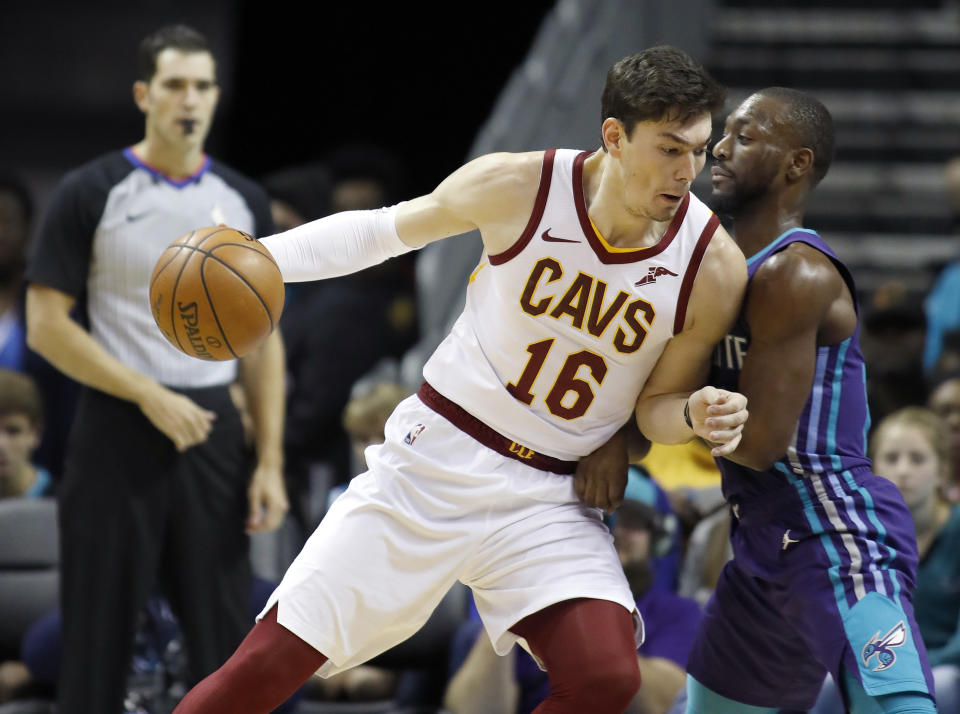FILE - In this Saturday, Nov. 3, 2018, file photo, Cleveland Cavaliers' Cedi Osman (16) leans a shoulder into Charlotte Hornets' Kemba Walker (15) during the first half of an NBA basketball game in Charlotte, N.C. The Cavaliers’ list of injured players continues to grow. Starting forward Cedi Osman will miss at least one game with back spasms, the fourth Cleveland player sidelined by an injury. (AP Photo/Bob Leverone, File)