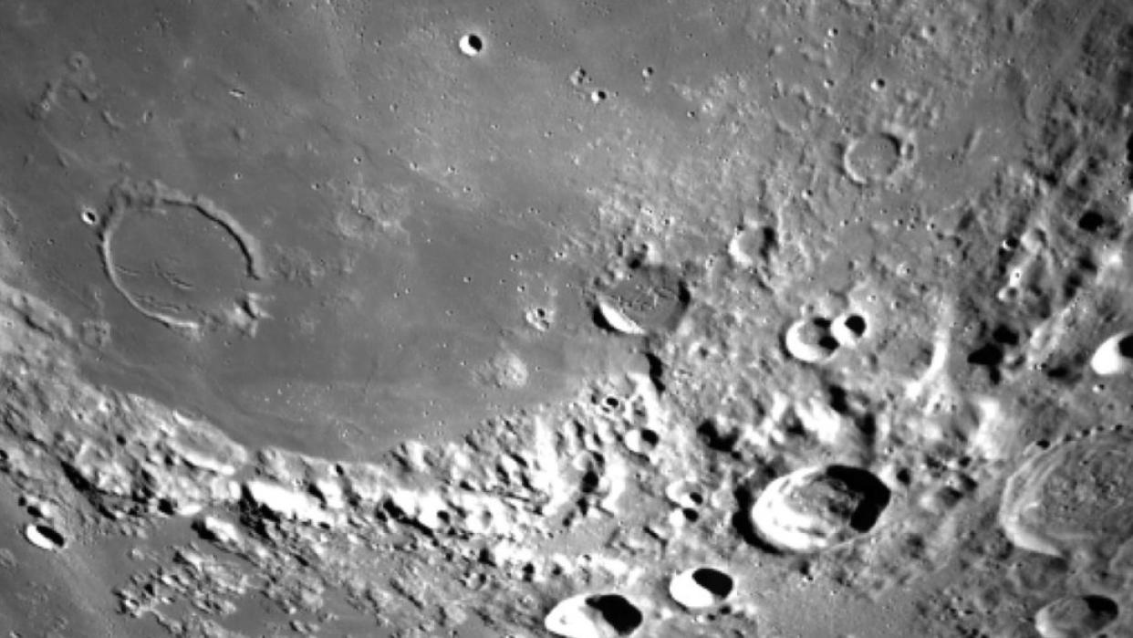  closeup of the moon's surface, showing numerous craters 