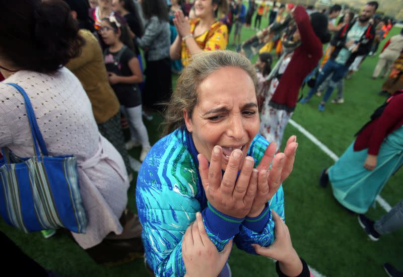 Aida, 41, celebrates the victory of her team, in an annual local soccer tournament in the village of Sahel