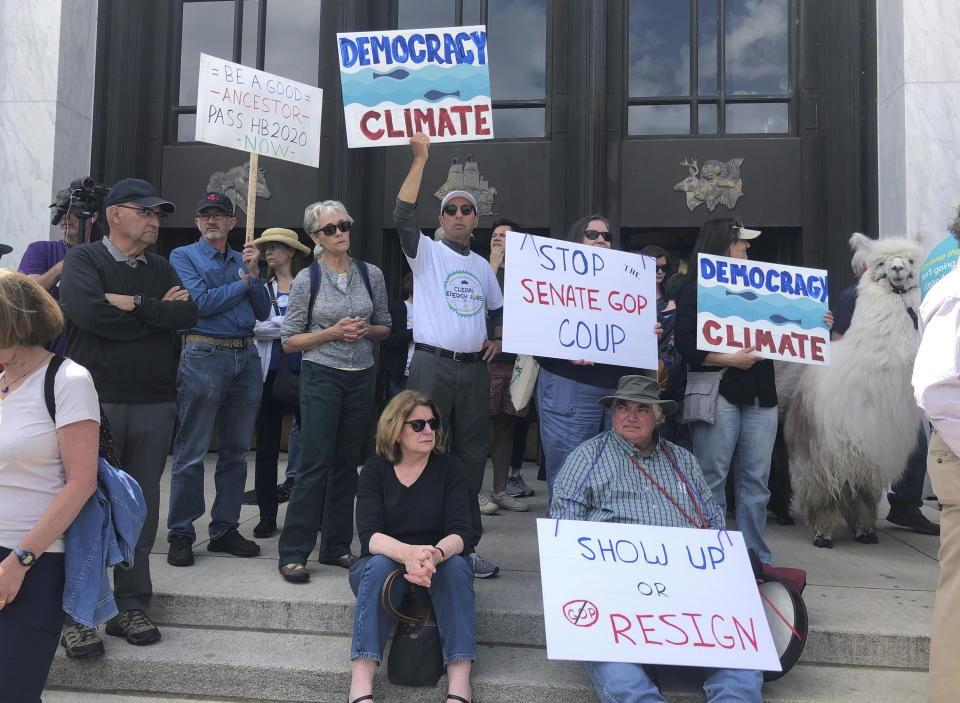 Protesters flood the steps of the Oregon State Capitol Tuesday, June 25, 2019, to push back against a Republican walkout over a climate change bill that has entered its sixth day in Salem, Ore. The president of the Oregon Senate said Tuesday there weren't enough votes in his majority Democratic caucus to approve a landmark climate bill that has sparked a walkout by Republicans and left other key issues such as the state budget in limbo. (AP Photo/Sarah Zimmerman)